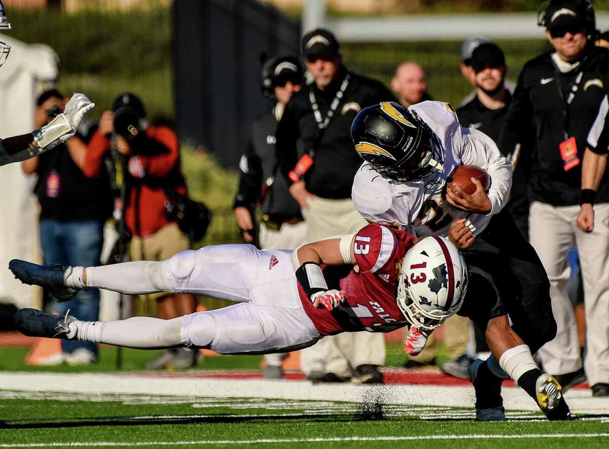 Wilcox's Luther Glenn is tackled by Scripps Ranch's Reece Keahey in the CIF State 2-A Championship game on Saturday, Dec. 11, 2021 at Saddleback College in Mission Viejo, Calif.