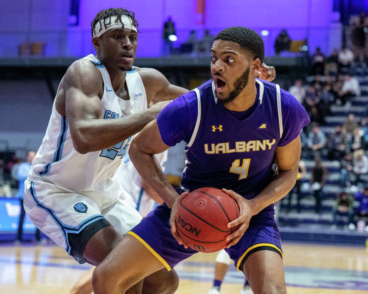 UAlbany graduate student Jarvis Doles drives to the basket in front of Columbia University junior Ike Nweke at SEFCU Arena. Lehigh, the Great Danes' opponent on Tuesday, has also beaten Columbia for its lone win.
