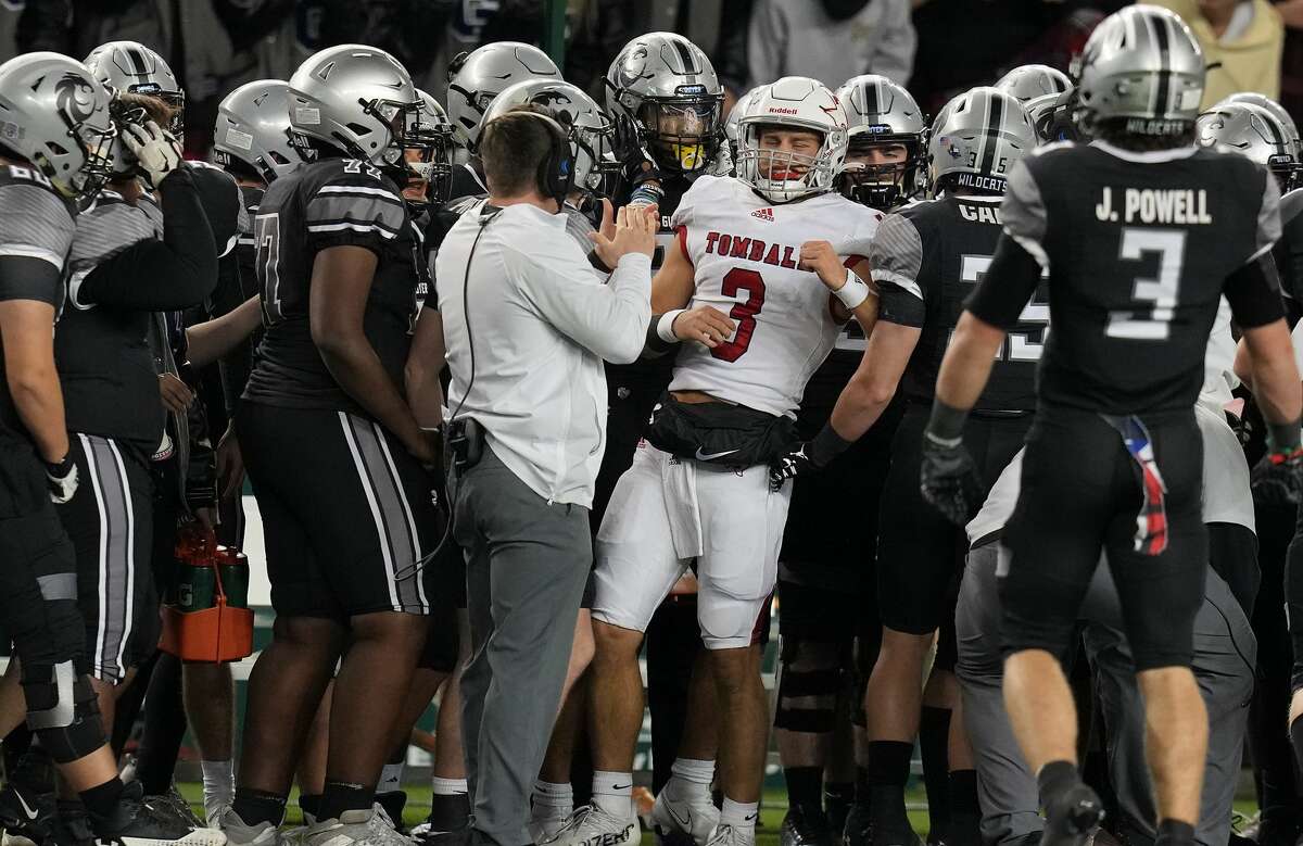 Tomball quarterback Cale Hellums (3) gets stuck in Denton Guyer's bench during Class 6A Division II state semifinal at Baylor University's McLane Stadium in Waco on Saturday, Dec. 11, 2021.