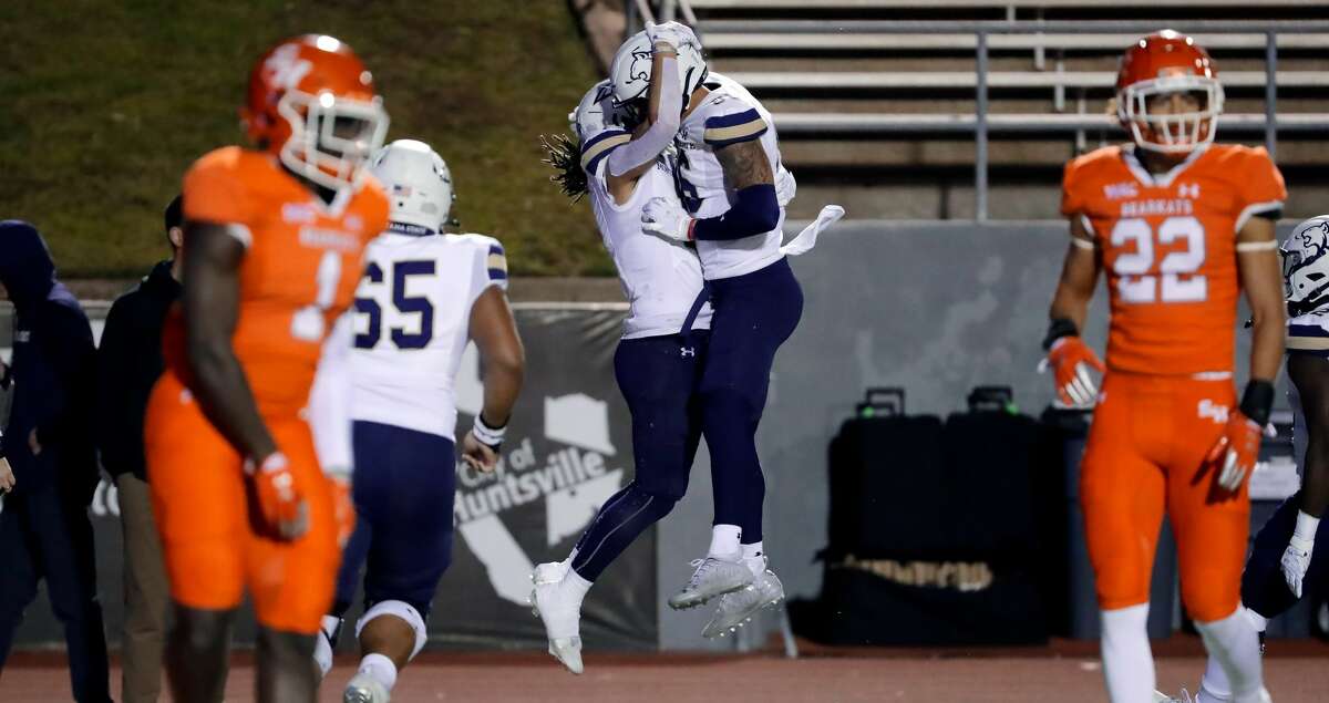 Montana State wide receiver Willie Patterson, left, and Lance McCutcheon, right, celebrate Patterson's touchdown catch against Sam Houston State during the first half of their third round FCS football game Saturday, Dec. 11, 2021 in Hunstville, TX.
