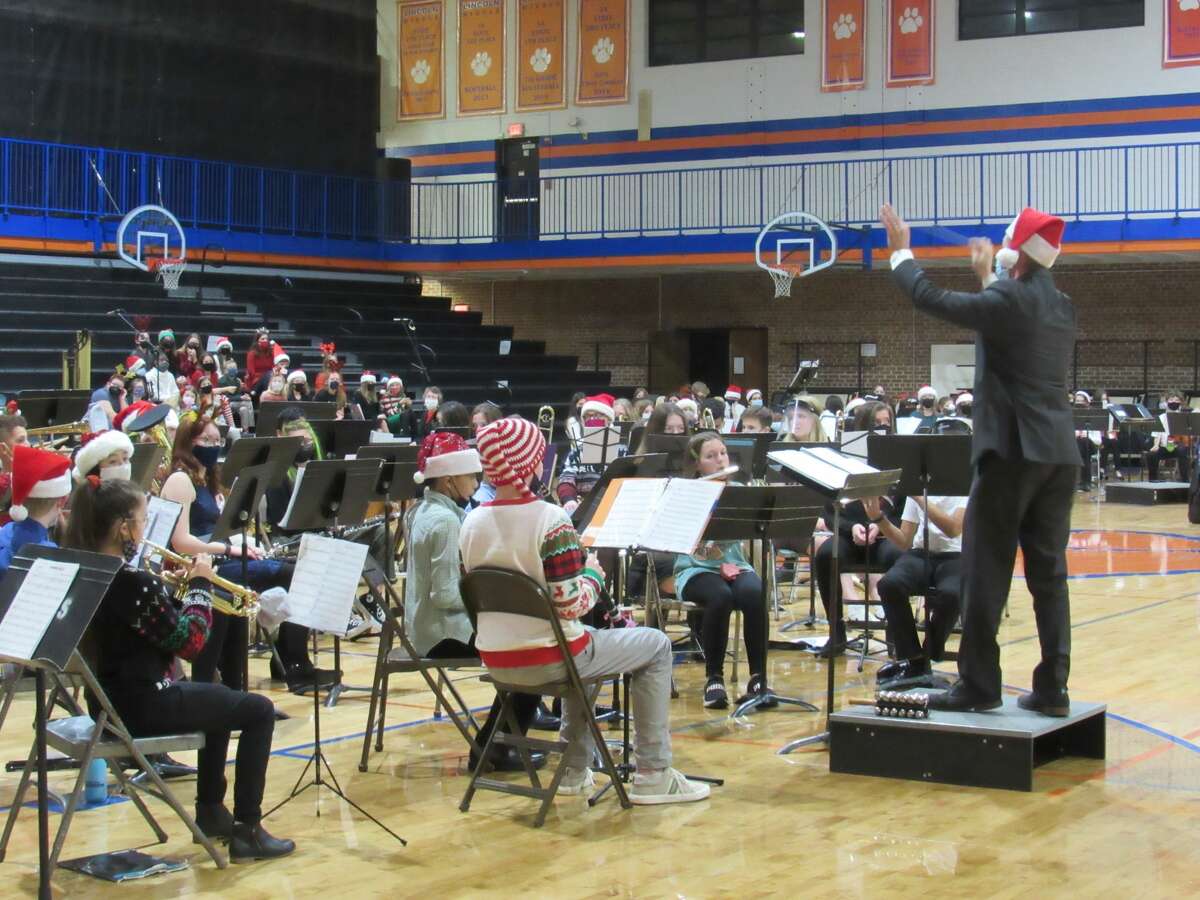 Rob Campbell directing the sixth grade band during the holiday performing arts concert Thursday night. 