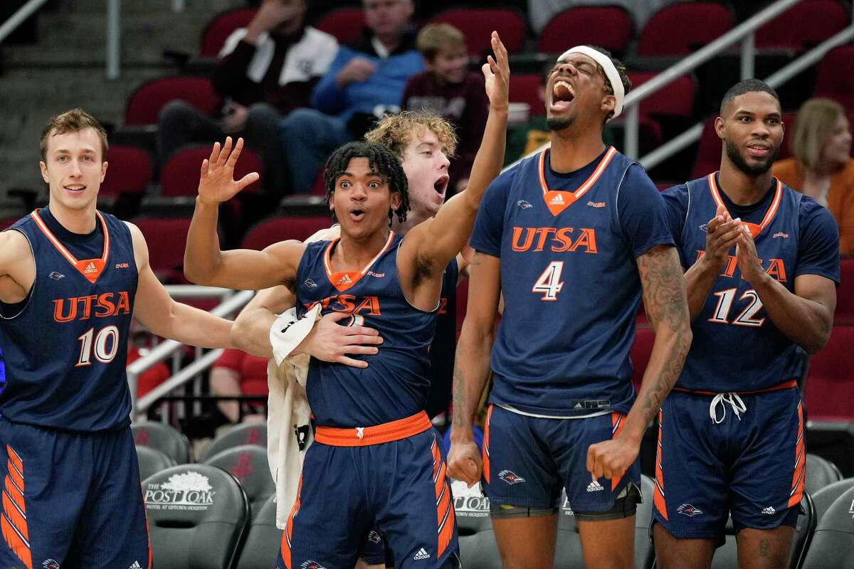 UTSA forward Josh Farmer (4) and teammates react to a dunk by forward Cedrick Alley Jr. during the second half of an NCAA college basketball game against Sam Houston State, Saturday, Dec. 11, 2021, in Houston.