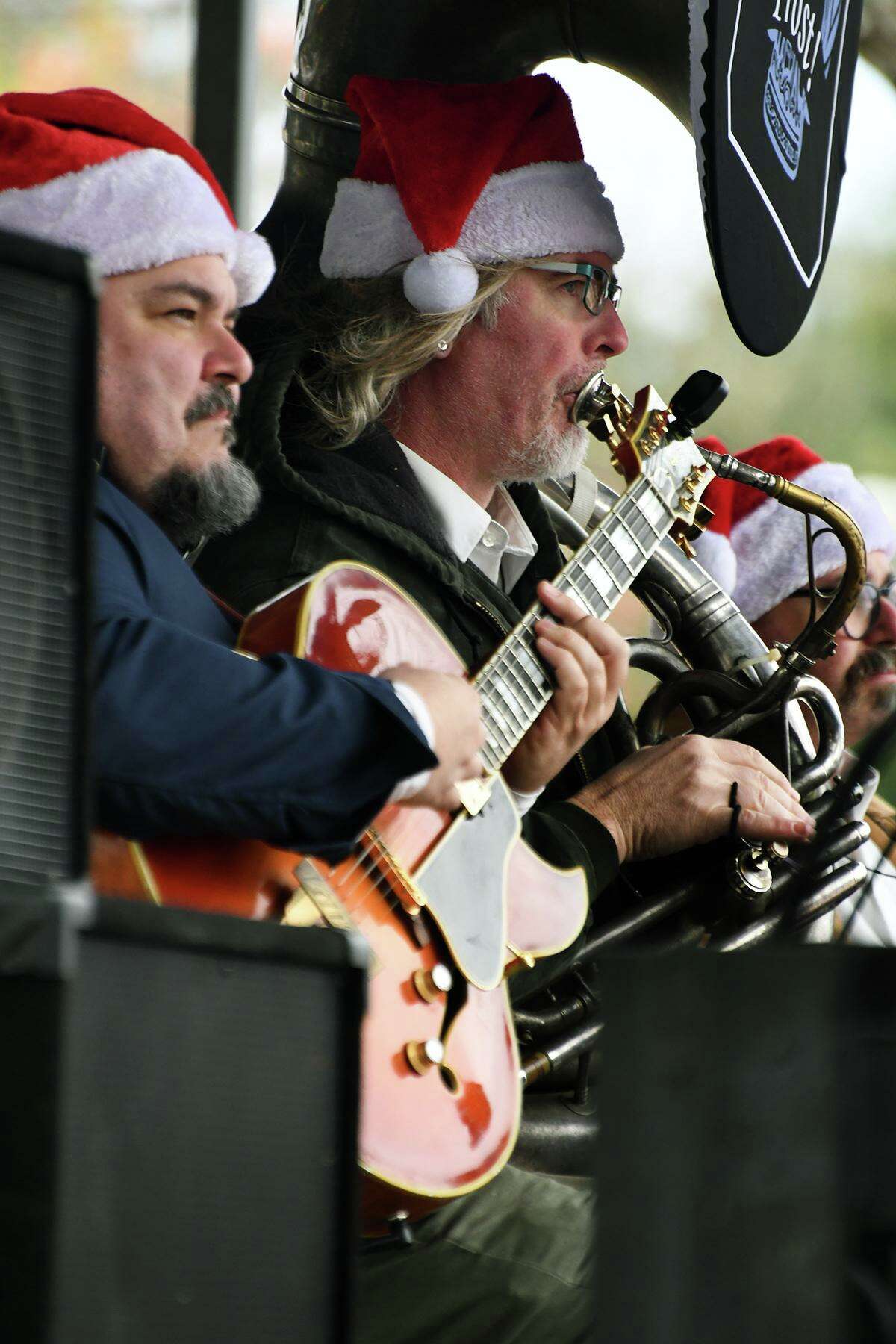 Prost! musicians, including Michael Vitori, from left, and Thomas Helton, serenade guests from the Warsteiner/Ziegenbock Wiesn stage during Tomball's 13th Annual German Christmas Market on Saturday, Dec. 11, 2021.