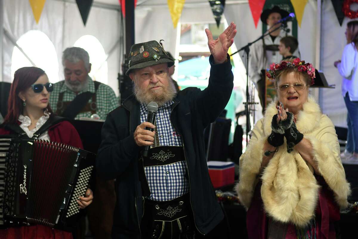 Grady Martin, center, co-founder of the Tomball Sister City Organization with his wife Sandra, right, speaks during the opening ceremonies of Tomball's 13th Annual German Christmas Market in the Telgte Dancehall on Saturday, Dec. 11,2021.