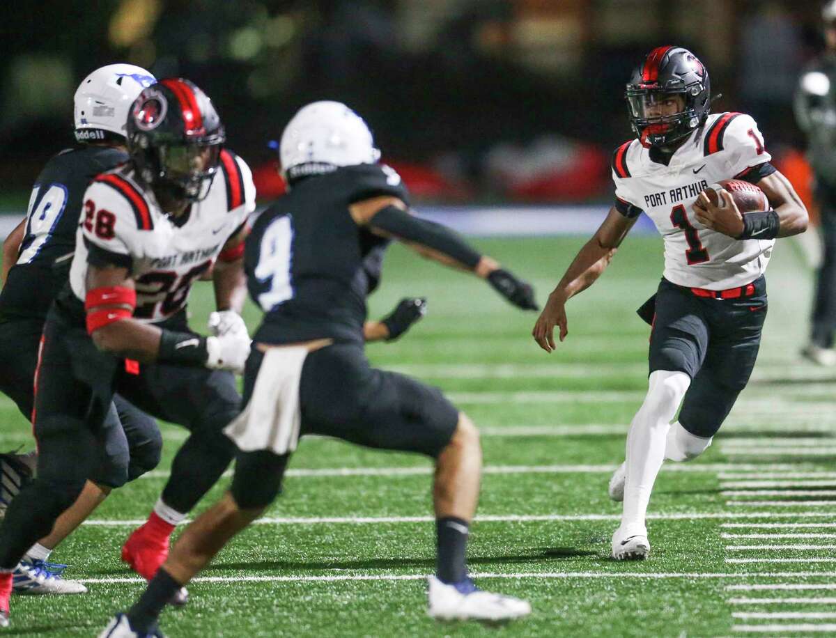 Port Arthur Memorial Titans quarterback Jahmar Sanders (1) rushes for seven yards against the Friendswood Mustangs in the first half in a District 9-5A Division I high school football game in the first half on November 5, 2021 at Winston Stadium in Houston, TX.
