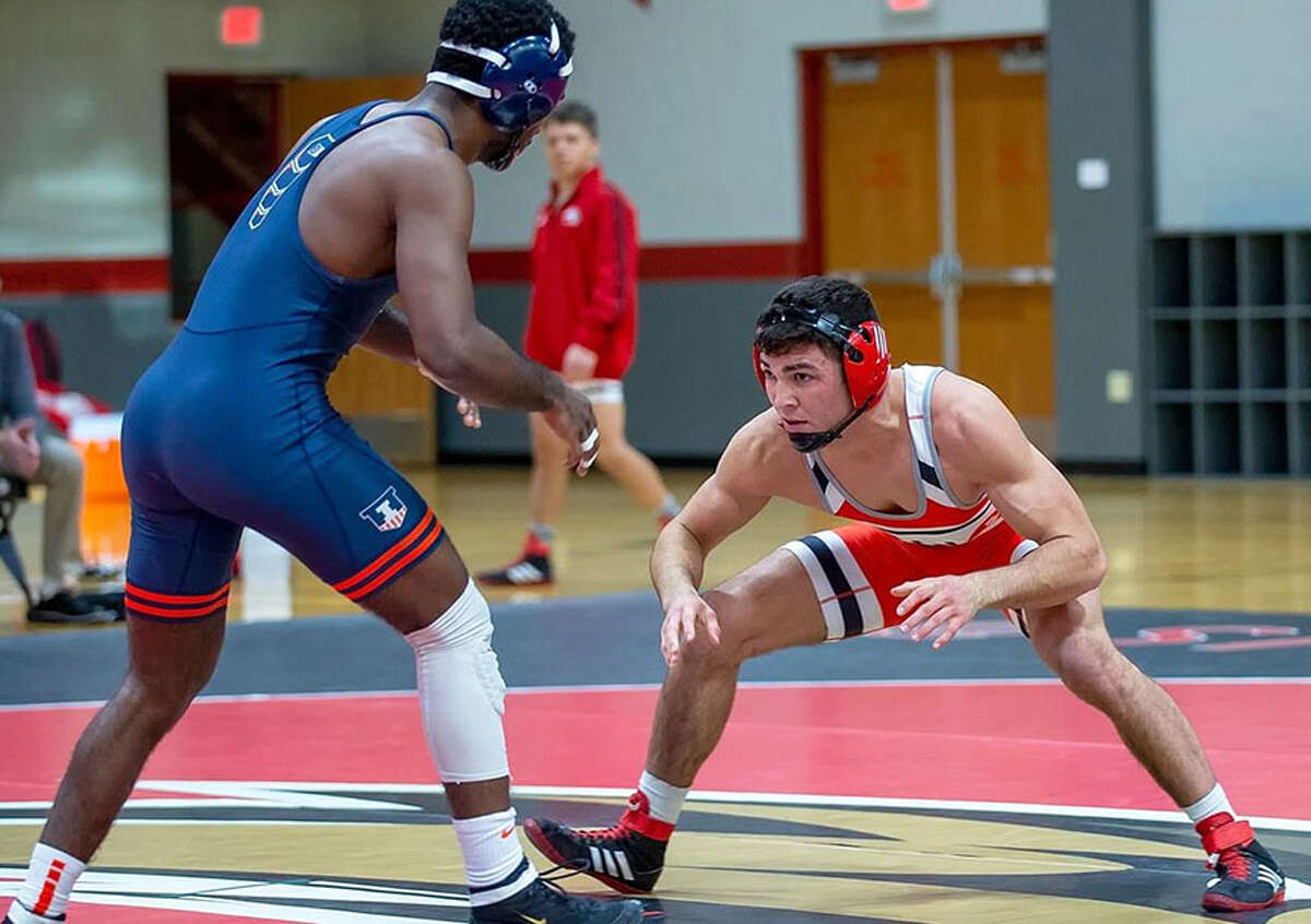 SIUE's Saul Erwin (right) wrestles against Illinois' Dylan Duncan on Sunday at SIUE in Edwardsville. Erwin won two matches on the day.