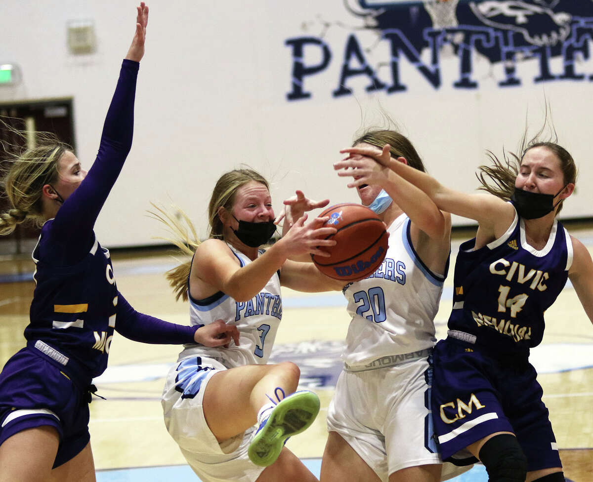Jersey's Kari Krueger (second left) had a career-high 15 rebounds in the Panthers' win Saturday at Carrollton. She is shown getting a rebound in traffic with teammate Elise Noble (20) and CM's Avari Combes (left) and Hannah Meiser (14) in a game earlier this season in Jerseyville.
