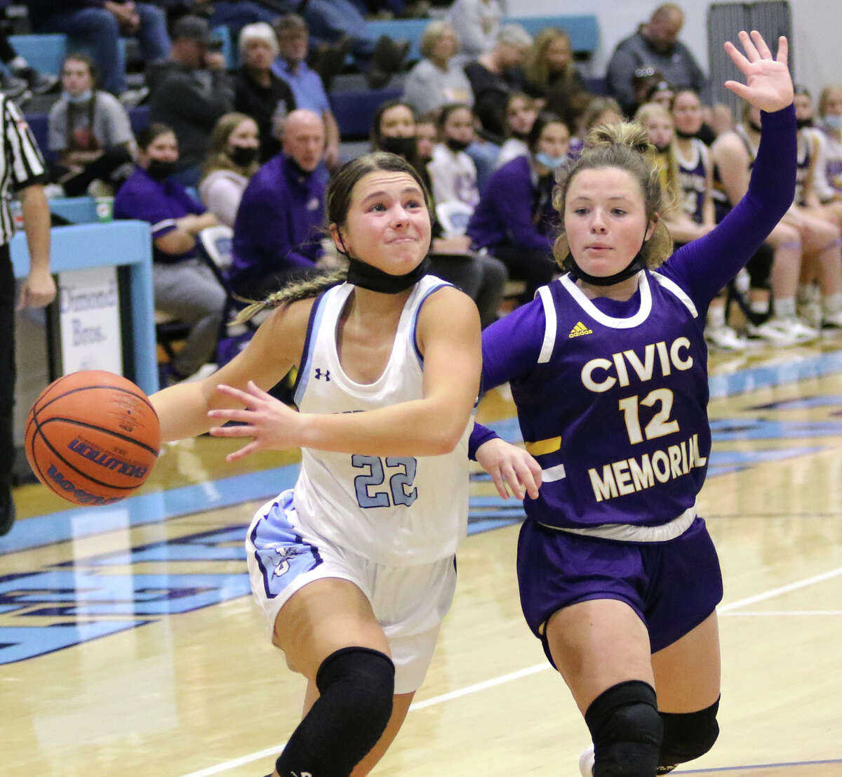 Jersey's Tessa Crawford (left), shown driving to the basket against CM's Aubree Wallace in a game earlier this season in Jerseyville, made four 3-pointers and scored 19 points Saturday in the Panthers' win at Carrollton.