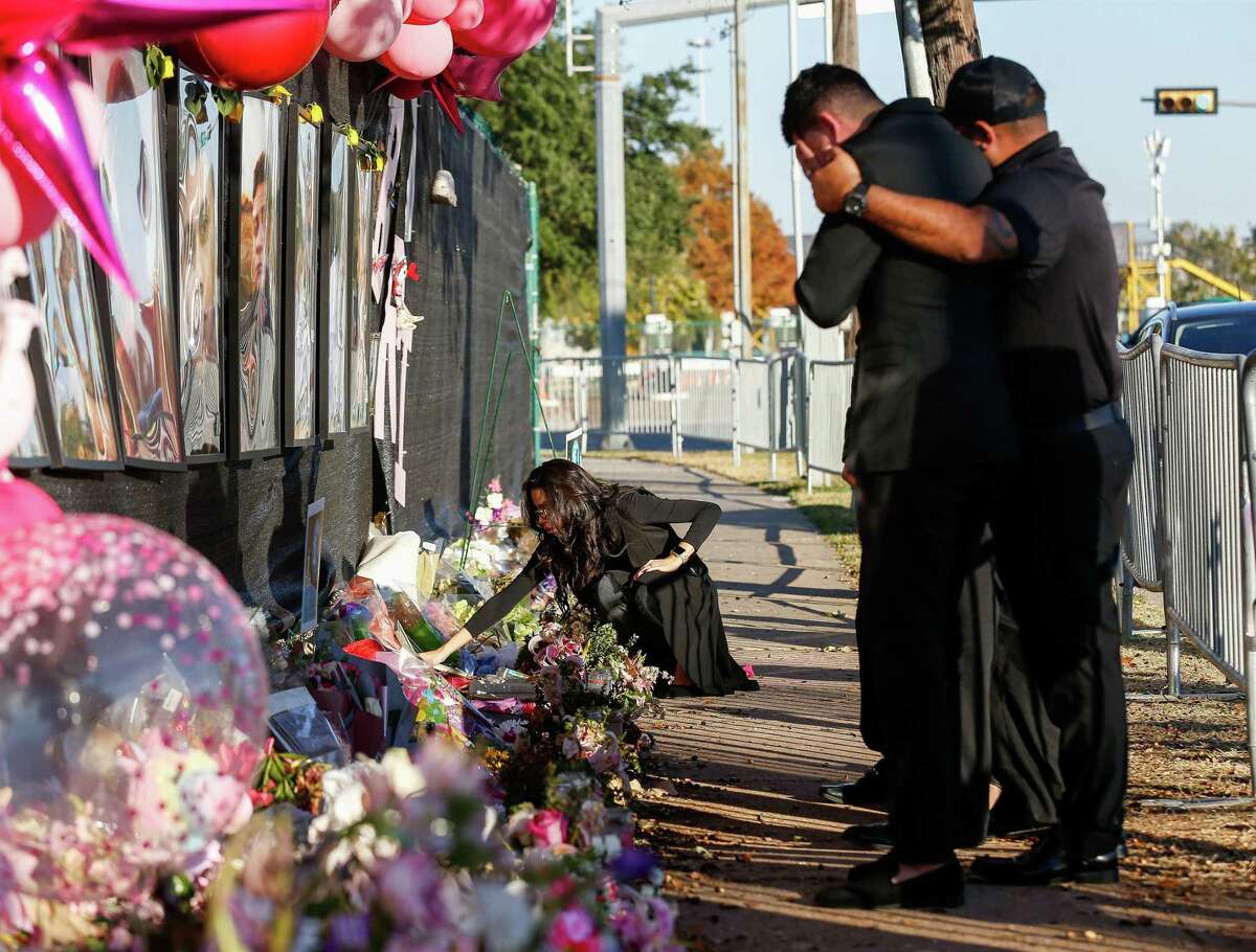 Jennifer Peña, center, dropped off flowers at the memorial for Astroworld Festival victims outside NRG Park on Monday, Nov. 29, 2021, in Houston. Her youngest brother, 23-year-old Rodolfo “Rudy” Peña, was one of the victims from the crowd surge at the festival.