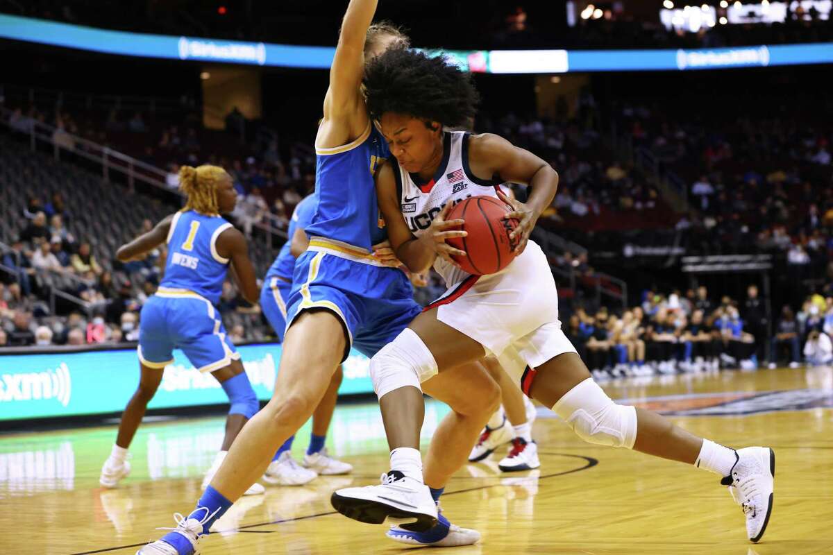 UConn’s Christyn Williams, right, drives to the basket as UCLA’s Chantel Horvat defends during the second half Saturday.