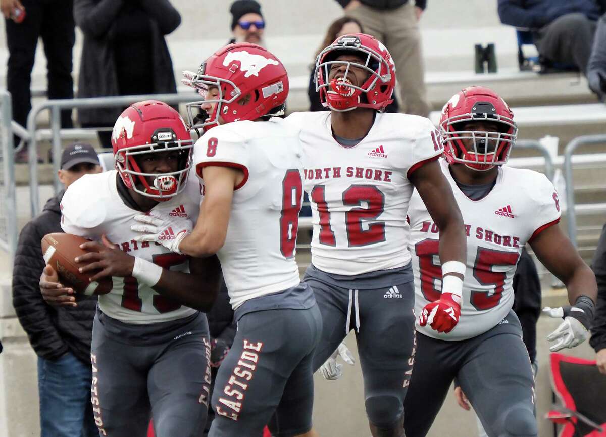 Dec. 11, 2021; Austin, Texas, USA; North Shore Mustangs Kaleb Bailey (15) and David Amador (8) and Jhalyn Bailey (12) and Talmadge Pounds (65) react after a touchdown against the Lake Travis Cavaliers in the second quarter in the Class 6A Division I state semifinal game at Reeves Stadium in Austin on Saturday. North Shore won 49-21. (Photo credit: Brendan Maloney / Chronicle)