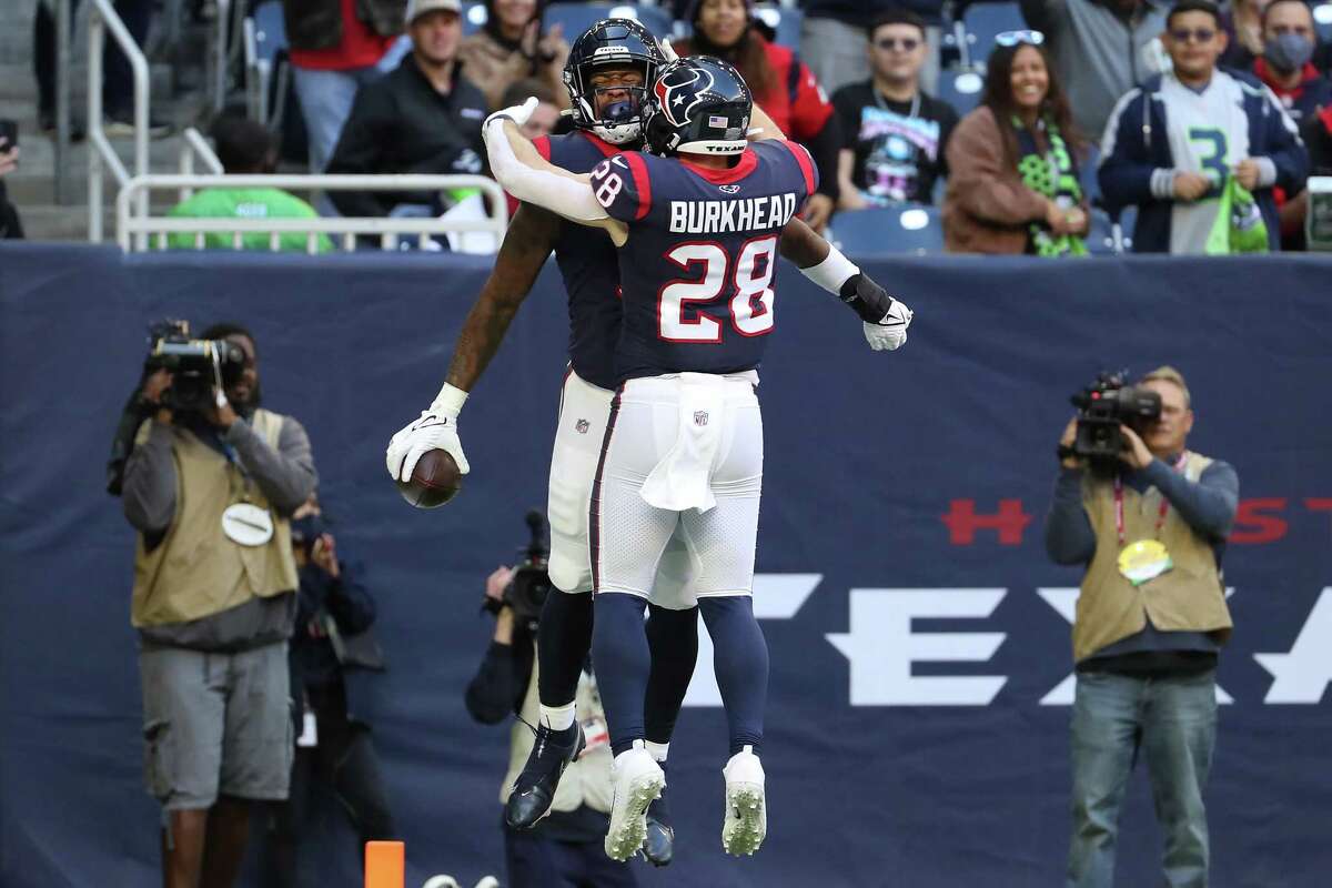Houston Texans tight end Brevin Jordan (9) and running back Rex Burkhead (28) celebrates Jordan’s 5-yard touchdown reception against the Seattle Seahawks during the first quarter of an NFL football game Sunday, Dec. 12, 2021 in Houston.