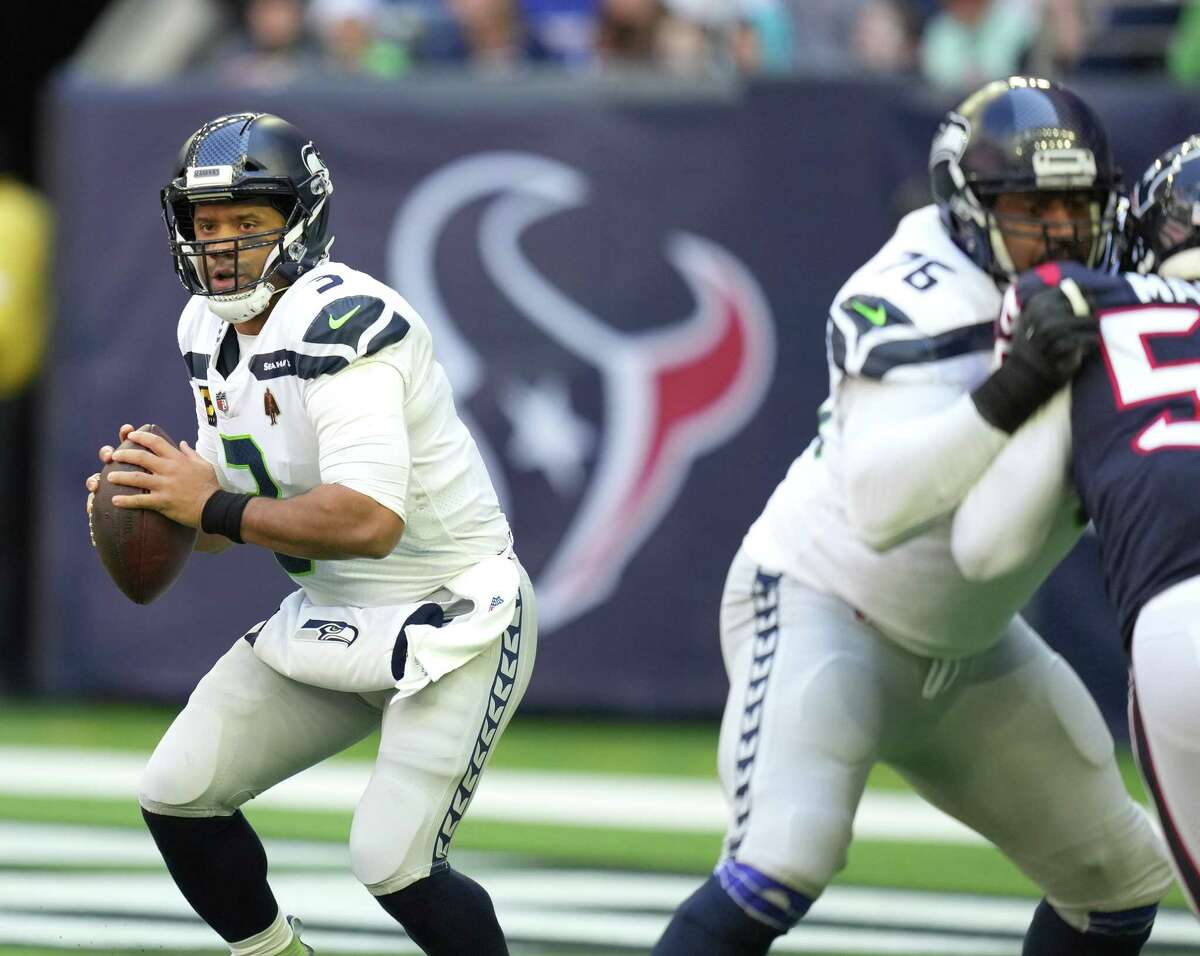 Seattle Seahawks quarterback Russell Wilson (3) looks to pass the ball during the first half of an NFL football game at NRG Stadium, Sunday, Dec. 12, 2021 in Houston .