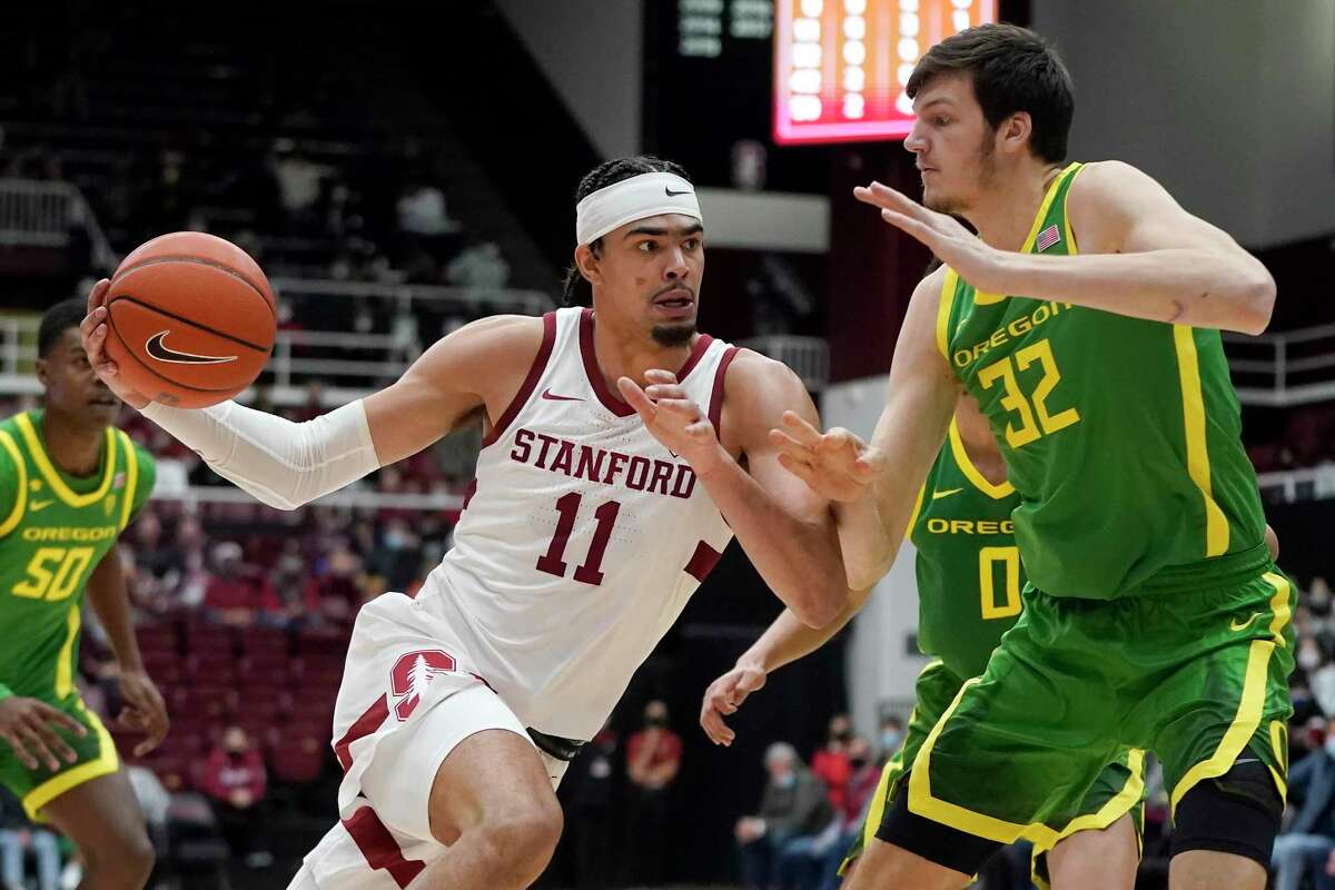 Stanford forward Jaiden Delaire (11) drives to the basket against Oregon center Nate Bittle (32) during the first half of an NCAA college basketball game in Stanford, Calif., Sunday, Dec. 12, 2021. (AP Photo/Jeff Chiu)