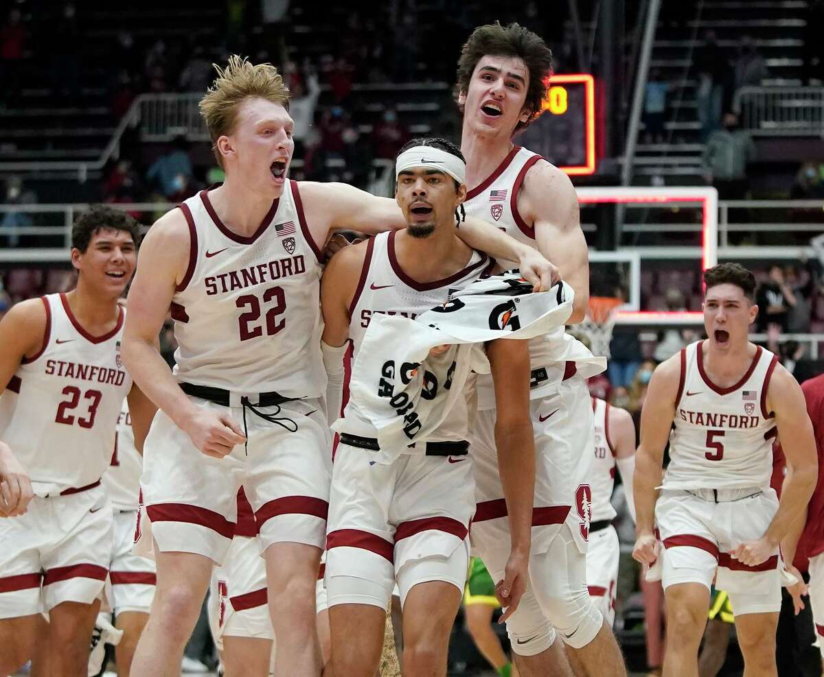 Stanford’s Jaiden Delaire (middle) celebrates with teammates after hitting the winning basket.