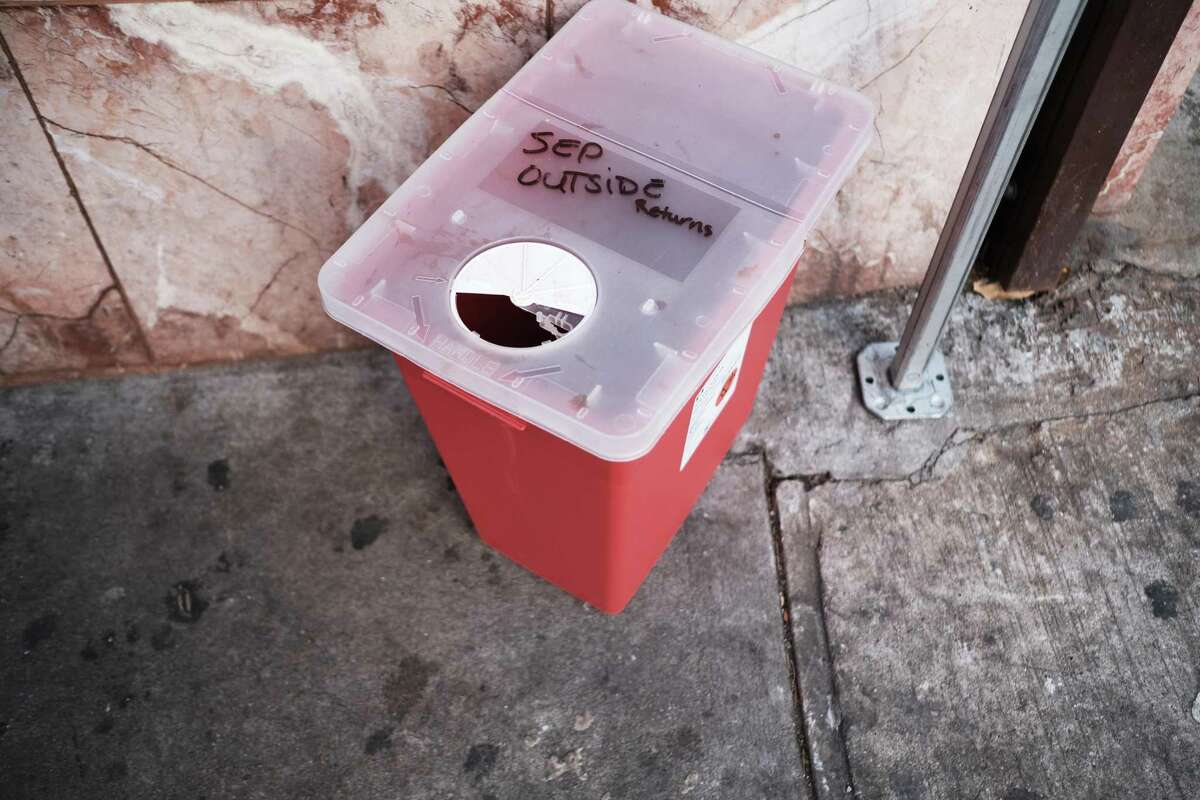 A bin for dirty needles sits outside of an East Harlem health clinic that provides free needles and other services to drug users on December 01, 2021 in New York City. New York Mayor Bill de Blasio has announced that New York City has opened two "Overdose Prevention Centers," the first supervised injection sites for drug users in the nation. The sites will offer drug users a safe and clean space to inject their drugs while being supervised in case of a medical emergency.