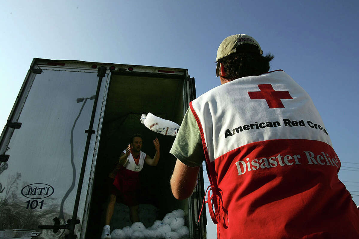 A file image of volunteers with the American Red Cross unloading bags of ice for people in need after Hurricane Katrina Sept. 14, 2005 in Biloxi, Miss. (Photo by Spencer Platt/Getty Images)