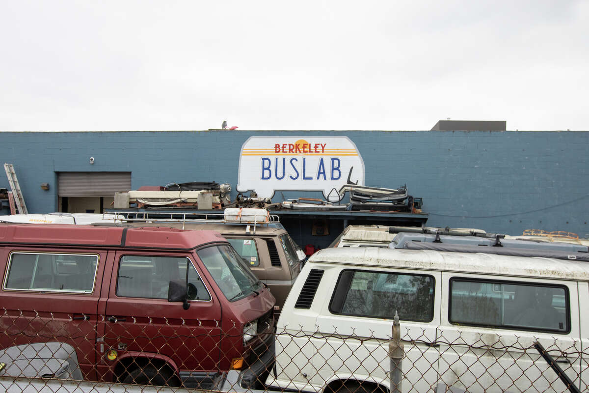 Several buses sit in the lot at Buslab, an auto mechanic shop that specializes in repairing Volkswagen vans, in Berkeley on Dec. 8, 2021.