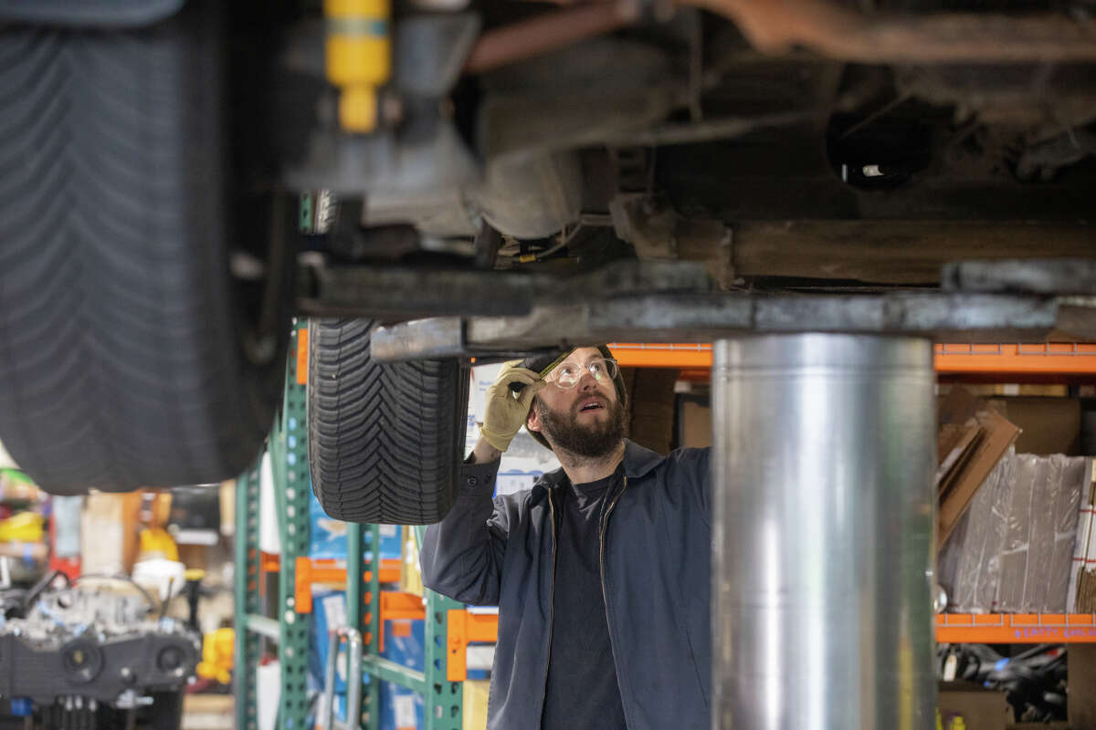 Mechanic Mikey Roesinger inspects a van at Buslab.