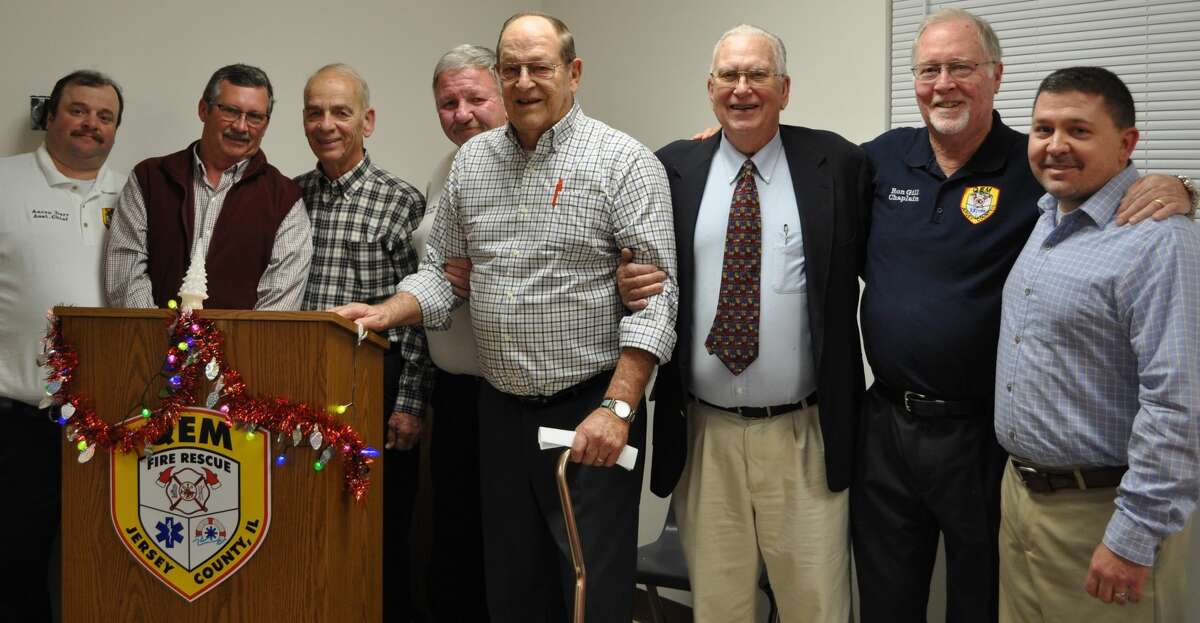 Danny Boirum, center, on Saturday was congratulated on his retirement as president of the QEM Fire Protection District Board of Trustees. From left are Aaron Darr, Assistant Fire Chief; Dennis Blackorby, Trustee; Alan Hauff, Secretary/Treasurer; Gerry New, Fire Chief; Boirum; Cy Bunting, Vice-President; Ron Gill, Chaplain; and Trustee; Ed Darabcsek, Trustee. 