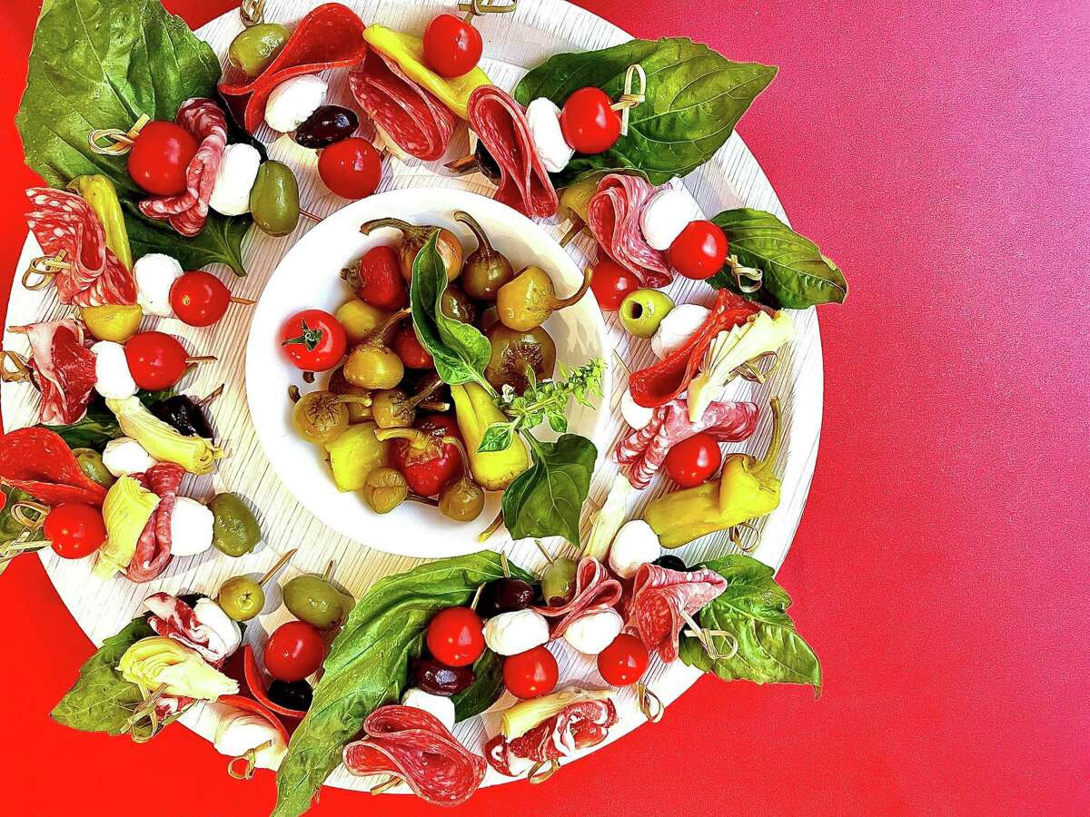This charcuterie wreath, perfect for holiday entertaining, is a simple arrangement of skewered antipasto bites.