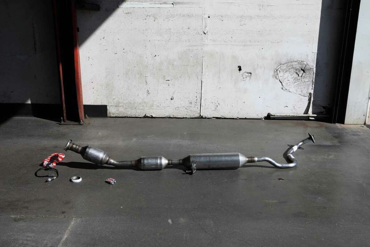 A catalytic converter sits on the ground as it awaits to be installed in a car at Johnny Franklin Muffler in Santa Rosa , Calif. San Jose police said they arrested 15 people and recovered around 1,000 allegedly stolen catalytic converters following a six-month investigation.