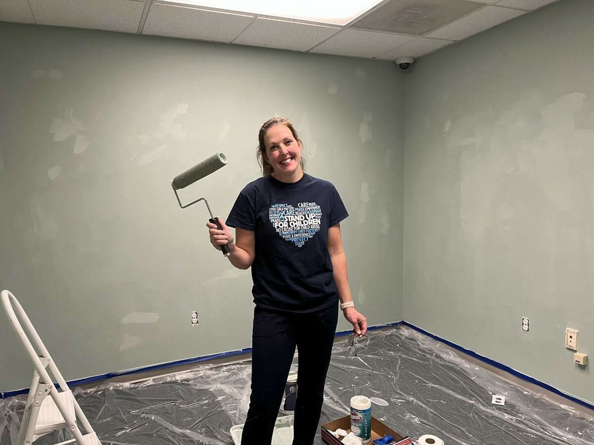 Megan McCarthy, the executive director of the Lakeshore Children's Advocacy Center, paints the wall at the center's new location at 385 Third St. in Manistee. The new location is next to the DHD#10 office. 