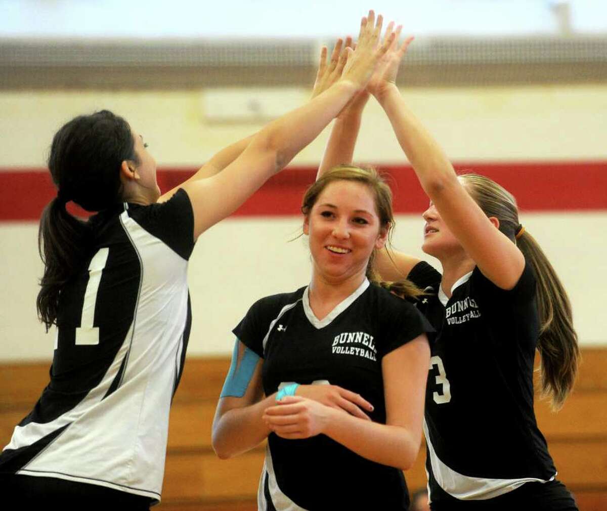 Members of the Bunnell High School volleyball team high-five after earning a point during Wednesday's game at Stratford High School on September 22, 2010.