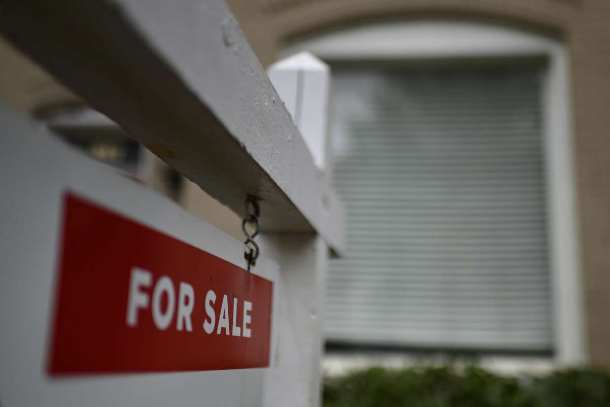 A sign "For Sale" is displayed in front of a house April 24, 2020, in Washington. (Photo by ERIC BARADAT/AFP via Getty Images)