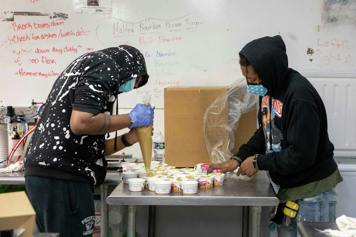 Maurice Reavis, left, and Deon Brown prepare ice cream at Taharka Brothers.