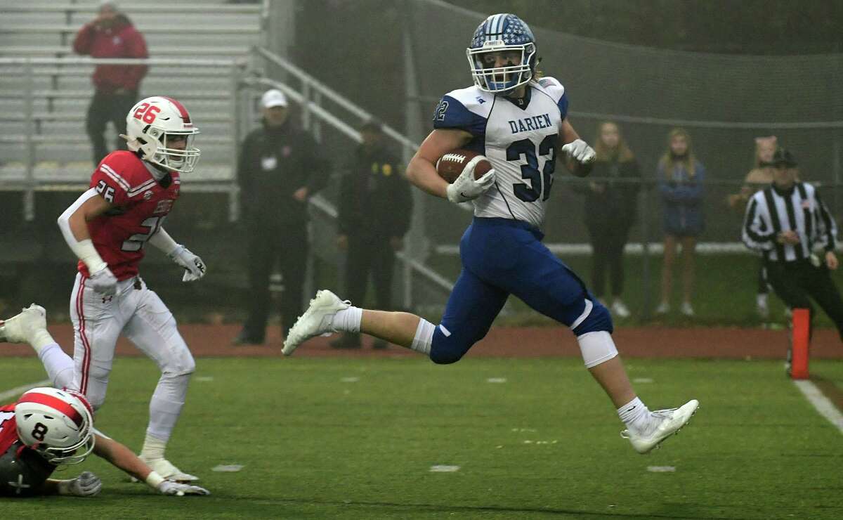 Blue Wave #32 Tighe Cummiskey scampers into the endzone during the Class LL state championship football game between No. 1 Fairfield Prep Jesuits and No. 3 Darien High School Blue Wave Saturday, December 11, 2021, at Trumbulll High School in Trumbull, Conn.