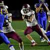 Killingly's Soren Rief (34) carries the ball on his way to score a touch down during CIAC Class M state championship football action against Rockville at Veterans Stadium in New Britain, Conn., on Saturday December 11, 2021.