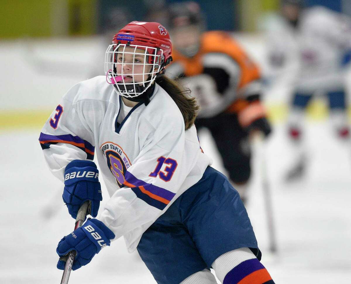Stamford-Westhill-Staples co-op center Meadow Gilchrist works the ice against Ridgefield-Danbury in 2019.