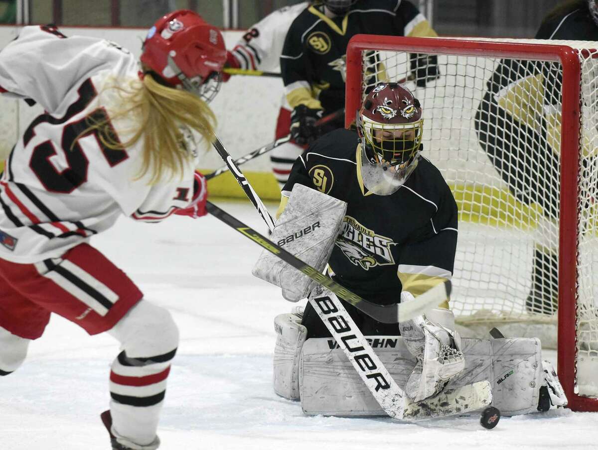 Trumbull/St. Joseph goalie Elsa Haakonsen makes a stop against New Canaan's Caitlin Tully (15) during the FCIAC girls ice hockey semifinals at the Darien Ice HOuse on Thursday, March 18, 2021.