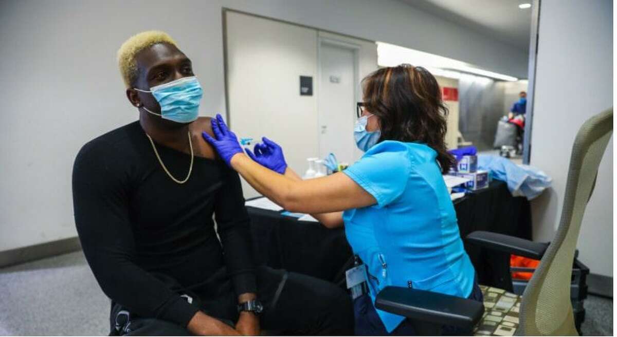 Quintyne Lawrence, 32, of San Francisco receives a Johnson and Johnson vaccine from Jojie Gooselaw, RN, at the SFO Medical Clinic at the San Francisco International Airport in San Francisco, Calif.