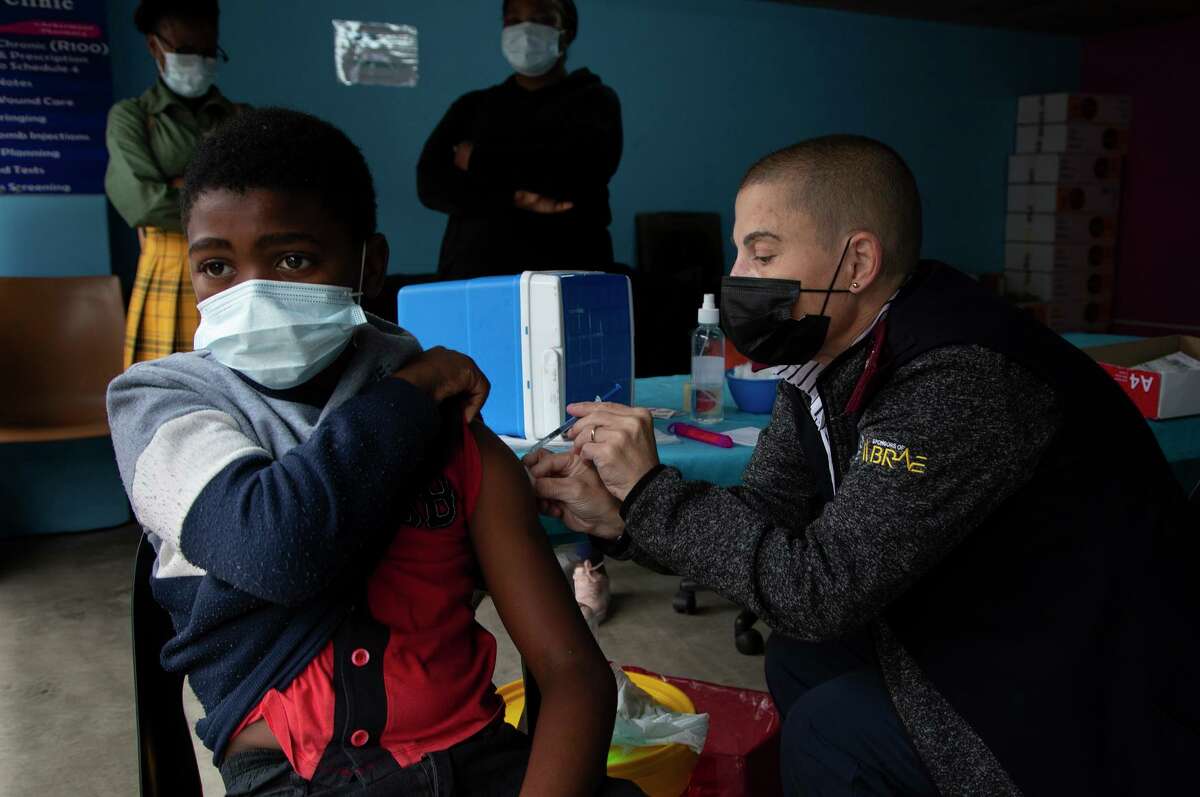 A boy gets vaccinated against COVID-19 at a site near Johannesburg, South Africa on Dec. 8.