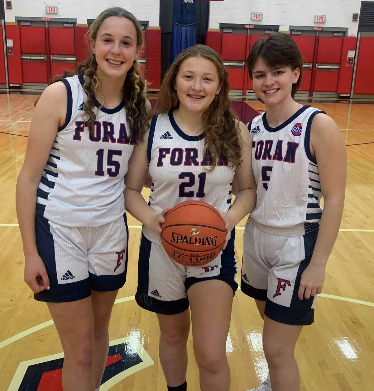 Courtney Musante, Mia Loewenberg and Abby Sanwald captain Foran's girls' basketball team.