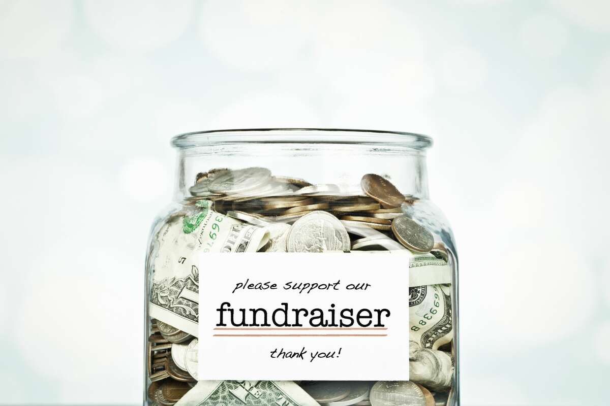Glass jar filled with donated money for a fundraiser