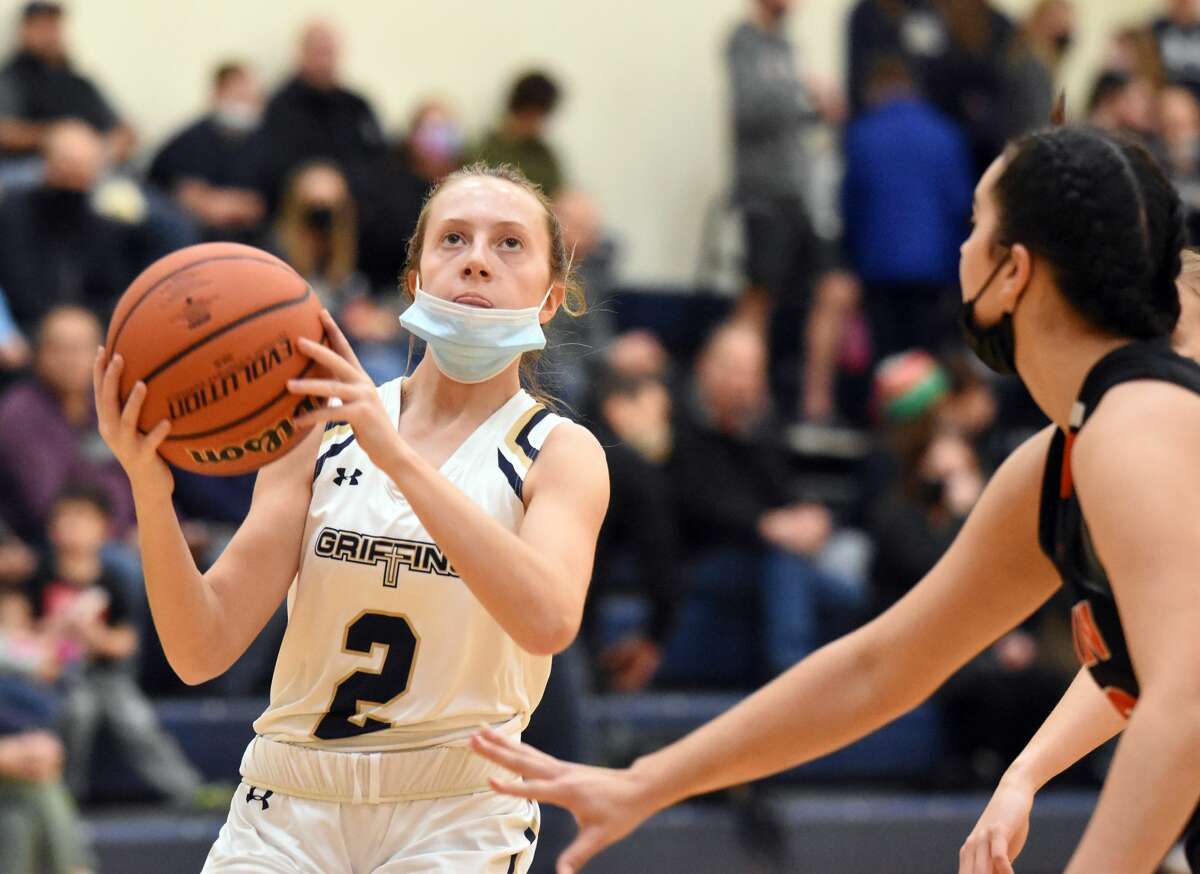 Father McGivney's Claire Stanhaus drives to the basket in the first quarter against Wesclin in Glen Carbon.
