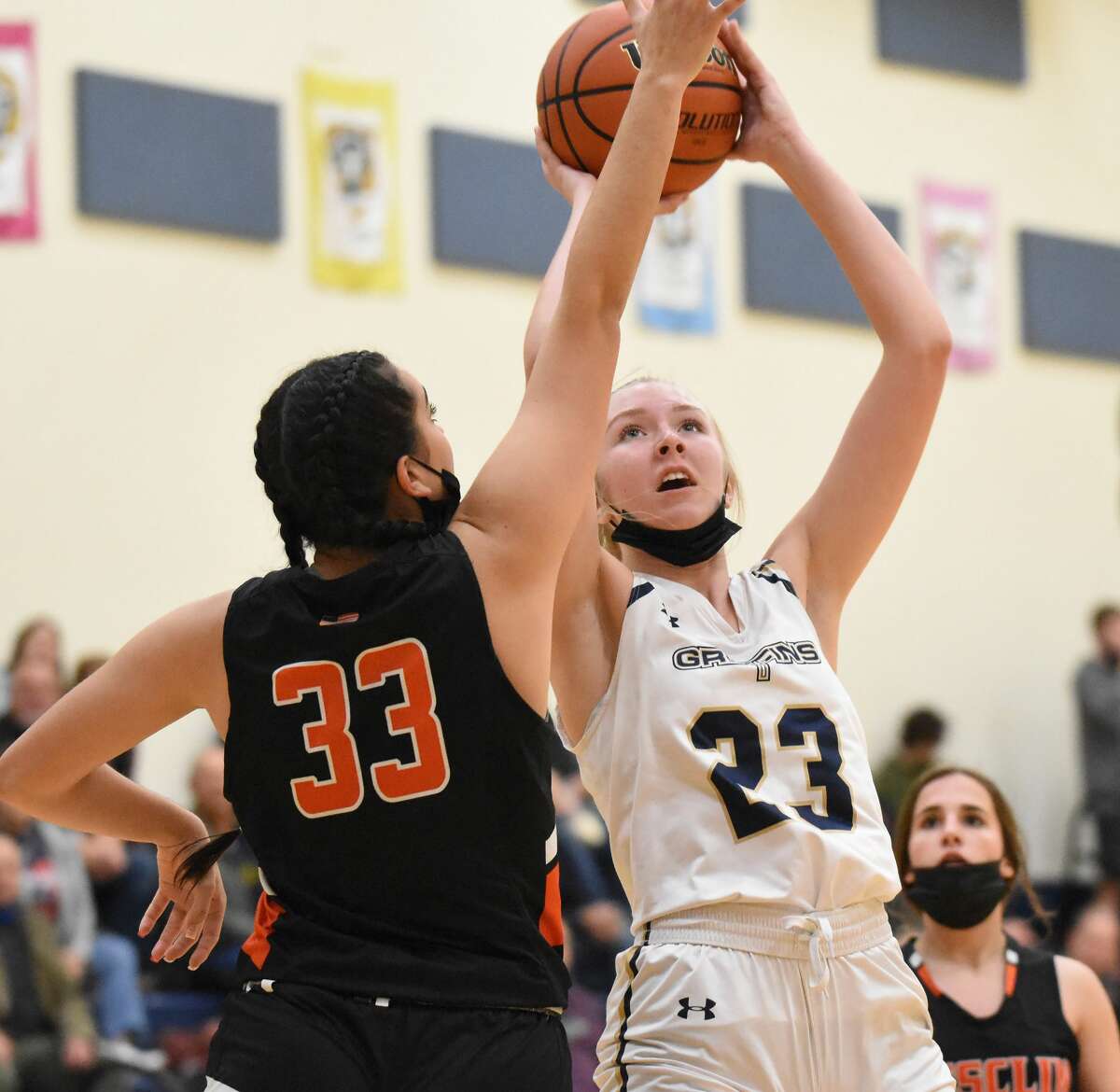 Father McGivney's Sami Oller, right, puts up a shot over a Wesclin defender during the second quarter in Glen Carbon.
