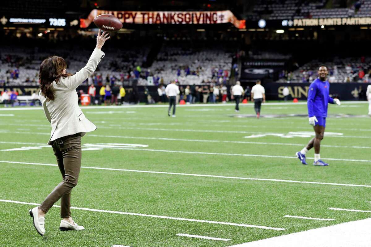 NBC Sports reporter Michele Tafoya throws the football to Buffalo Bills wide receiver Stefon Diggs (14) before an NFL football game against the New Orleans Saints, Thursday, Nov. 25, 2021, in New Orleans. (AP Photo/Tyler Kaufman)