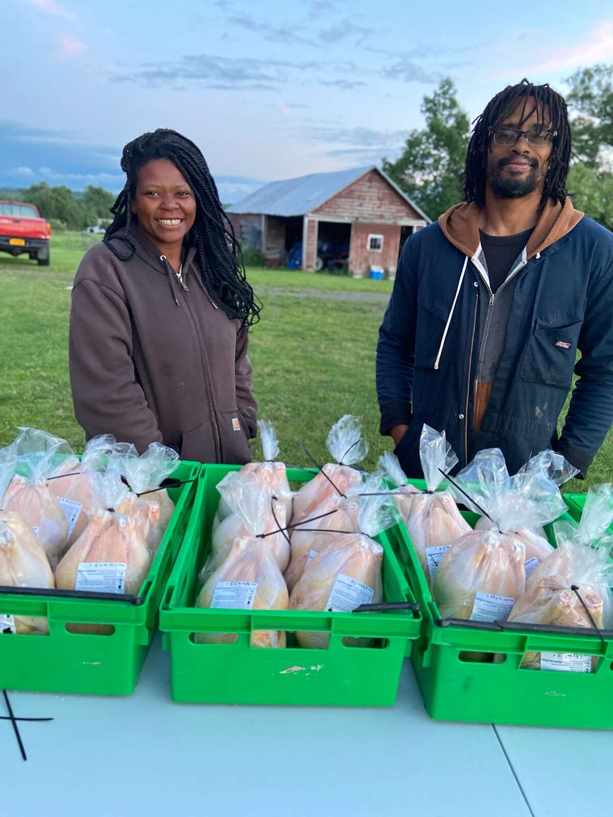 Ashanti Williams and Arian Rivera with farm-raised chickens for customers at their The Black Yard Farm Collective in Sloansville.