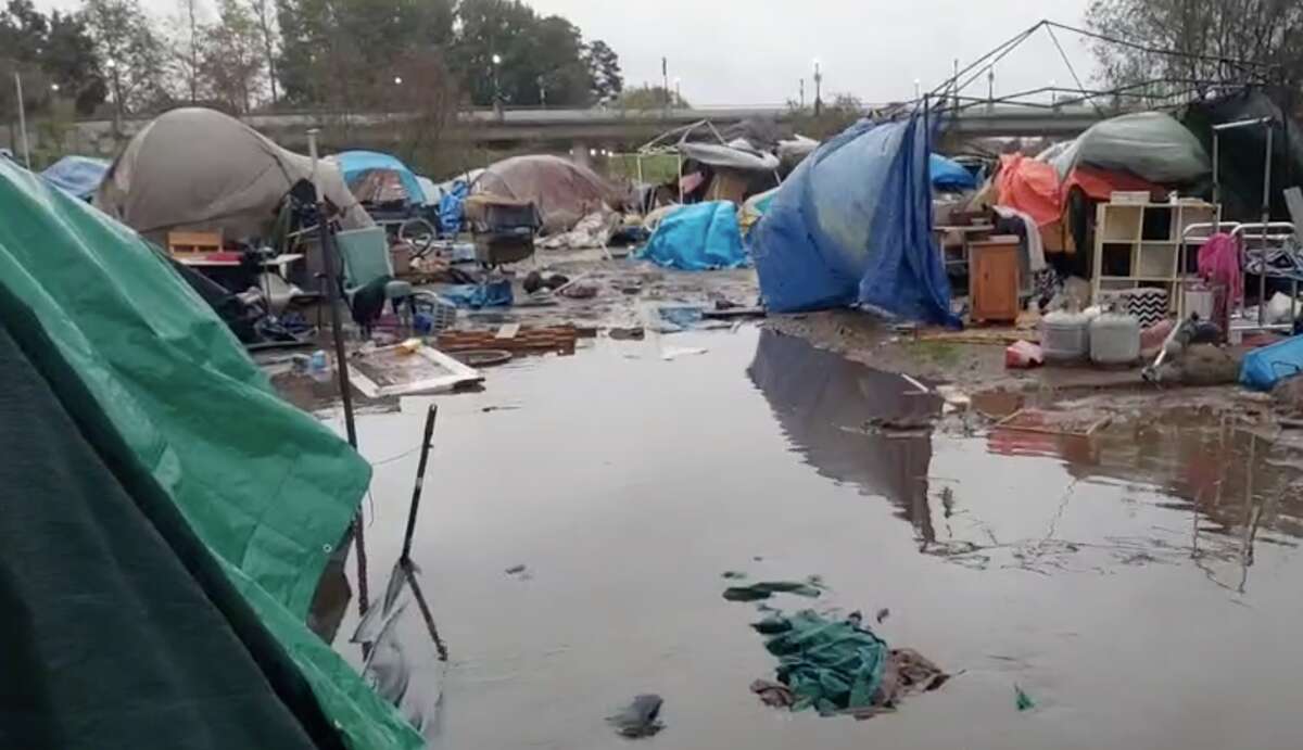 A screenshot showing the flooding of tents in an encampment along the San Lorenzo River in Santa Cruz, on Monday, Dec. 13.