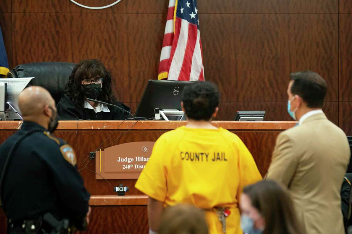 Eddie Alberto Miller, 19, makes his first court appearance in the 248th District Court with his court appointed public defenders, Tuesday, Dec. 14, 2021, in Houston. Miller was arrested Sunday in connection with the shooting death of Kareem Atkins, a Harris County Constable's Office deputy with Precinct Four. Police spent two months investigating the shooting, which injured two additional officers, before arresting Miller in Fort Bend County this weekend.