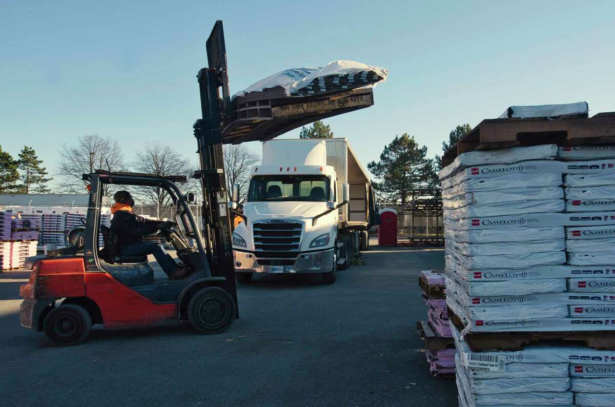 Building materials from their distribution center in Syracuse are unloaded from a Erie Materials tractor trailer at the company's Albany branch on Tuesday, Dec. 14, 2021, in Albany, N.Y. The distribution center services the company's nine branches.