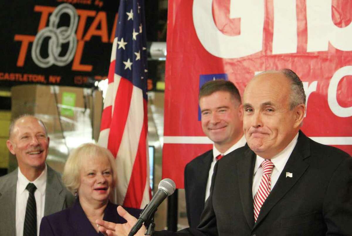 Ex-New York City Mayor Rudy Giuliani endorsed Chris Gibson, center, the GOP candidate for the 20th district at an event Wednesday at Total Tool Co. in Schodack, but he hit House Speaker Nancy Pelosi, not the incumbent. Total president Kathy Dederick is at left. (Chelsea Kruger/Times Union)