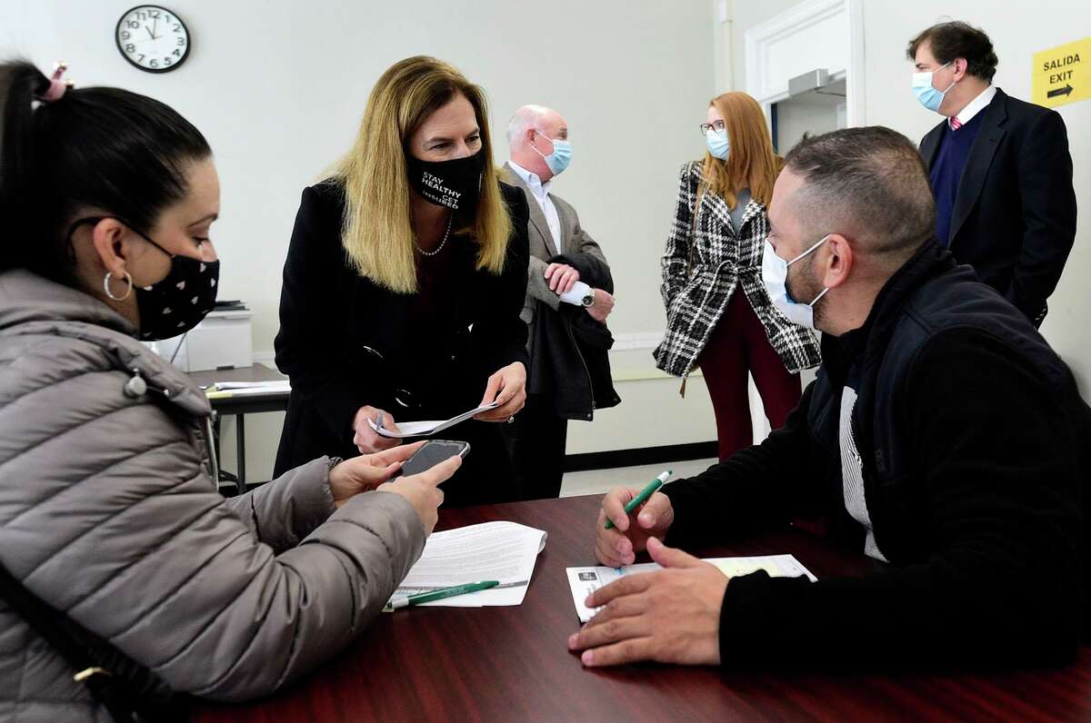 Connecticut Lt Governor Susan Bysiewicz, center, speaks with Stamford resident Angelica Cordilla and Ricardo Guarin at a pop up COVID vaccination clinic at Family & Childrem's Agency Tuesday December 13, 2021, in Norwalk, Conn.