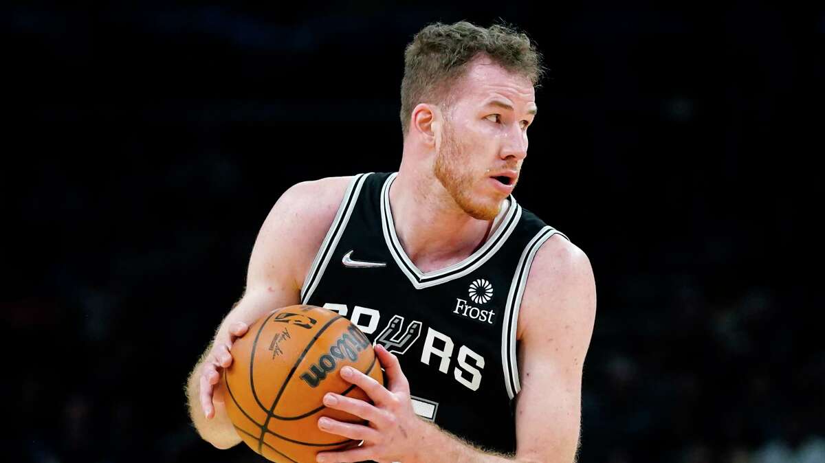 San Antonio Spurs center Jakob Poeltl grabs a rebound against the Phoenix Suns during the first half of an NBA basketball game Monday, Dec. 6, 2021, in Phoenix. (AP Photo/Ross D. Franklin)