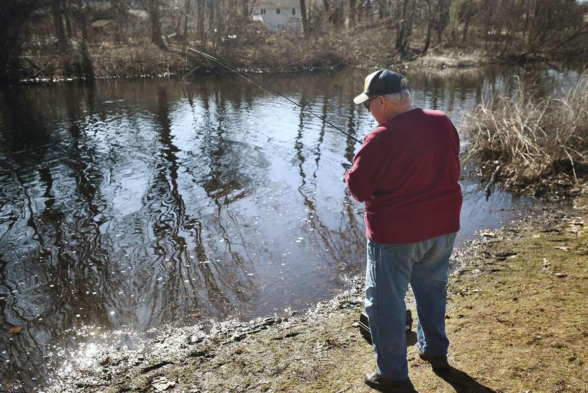 A Fairfield resident enjoys a morning of fishing on the Mill River in Fairfield on Sunday, March 21, 2021.