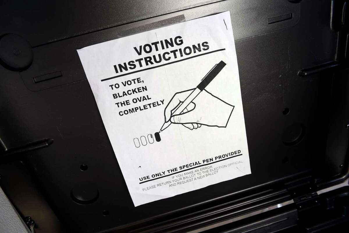 Voting instructions are posted inside a voting booth at the University of New Haven’s Student Hall polling location in a special election for the 116th District House seat in West Haven on Dec. 14, 2021.